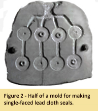 Image of half of a mold for making single-faced lead cloth seals.