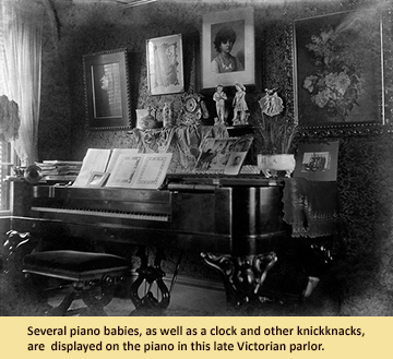 Several piano babies, as well as a clock and other knickknacks, are displayed on the piano in this late Victorian parlor.