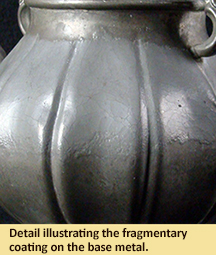 Detail illustrating the fragmentary coating on the base metal.