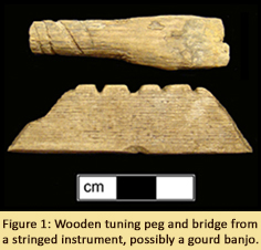 Figure 1: Wooden tuning peg and bridge from a stringed instrument, possibly a gourd banjo.