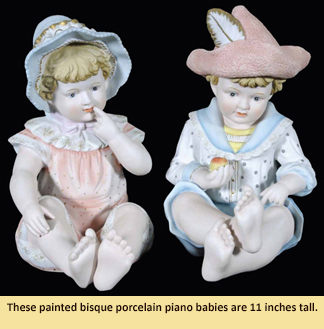 These painted bisque porcelain piano babies are 11” tall.